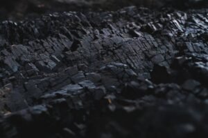 pexels-photo-2646237-2646237 A detailed close-up of dark charcoal texture, showcasing its rough and jagged surface.