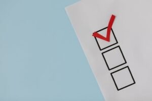 pexels-photo-8850706-8850706-1 A simple white paper checklist with one red checkmark, ideal for concepts like completion or approval.